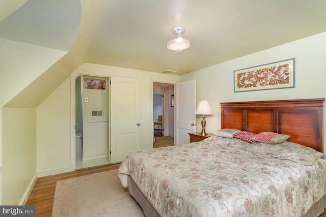 bedroom with visible vents, baseboards, and light wood-style flooring