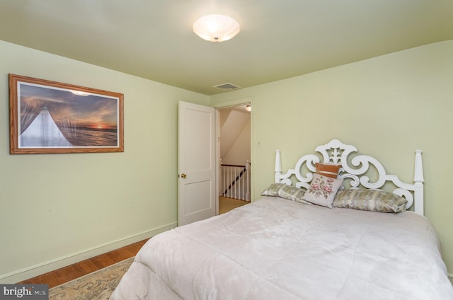 bedroom featuring wood finished floors and baseboards