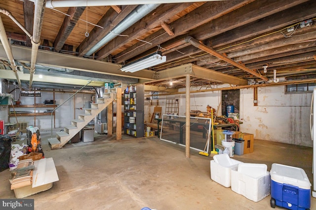 unfinished basement featuring stairs