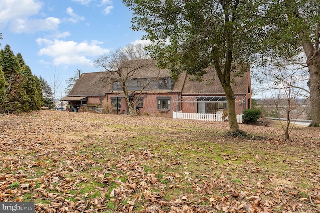 rear view of property with brick siding