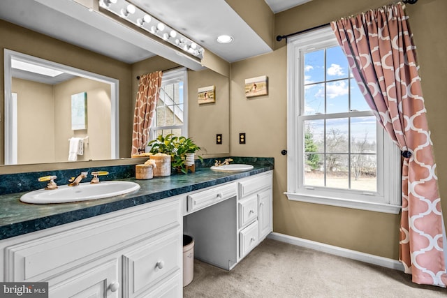 full bath with a healthy amount of sunlight and a sink