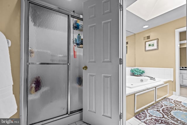 bathroom with tile patterned floors, visible vents, a stall shower, and a garden tub