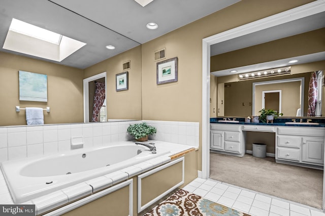 full bath with double vanity, visible vents, a skylight, and a whirlpool tub