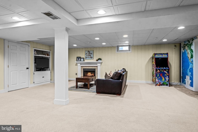 interior space with visible vents, baseboards, carpet, recessed lighting, and a warm lit fireplace