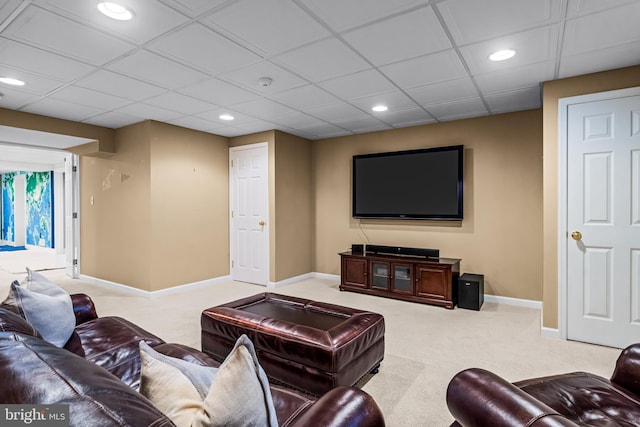 living room with a drop ceiling, recessed lighting, baseboards, and carpet