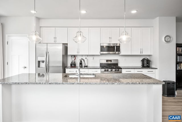 kitchen with white cabinetry, backsplash, appliances with stainless steel finishes, and a sink