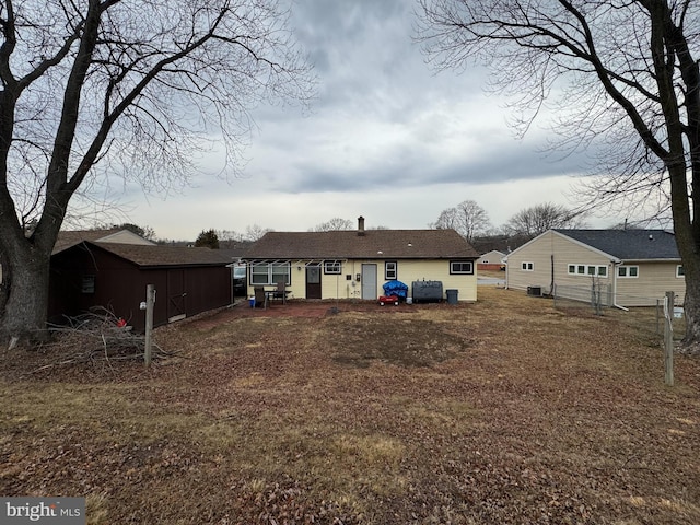 back of property with an outdoor structure