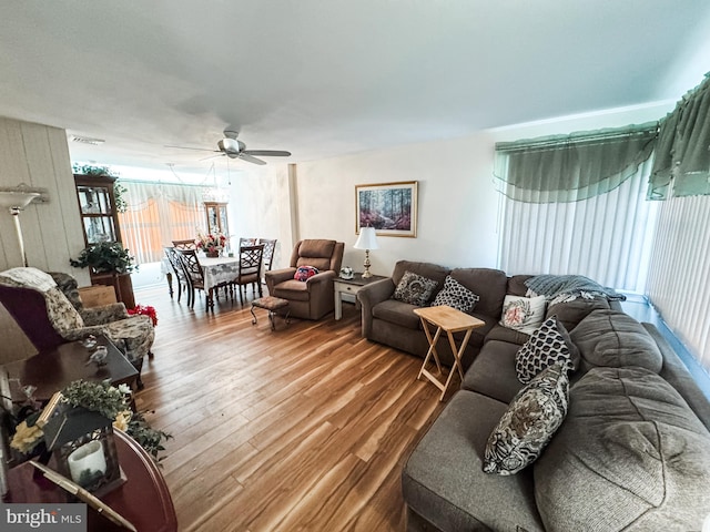 living room with wood finished floors and ceiling fan