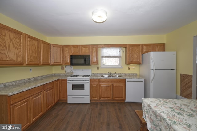 kitchen featuring white appliances, brown cabinetry, dark wood-style flooring, light countertops, and a sink