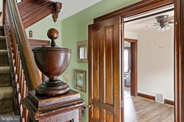 interior space featuring visible vents, stairs, baseboards, and wood finished floors