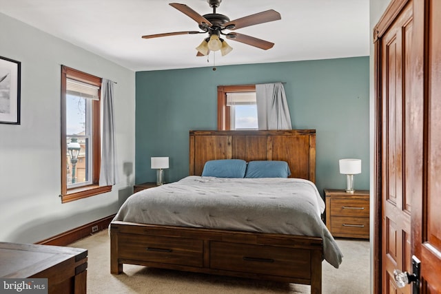 bedroom with a ceiling fan and light carpet