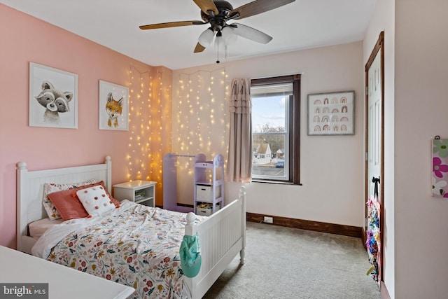 bedroom with baseboards and carpet