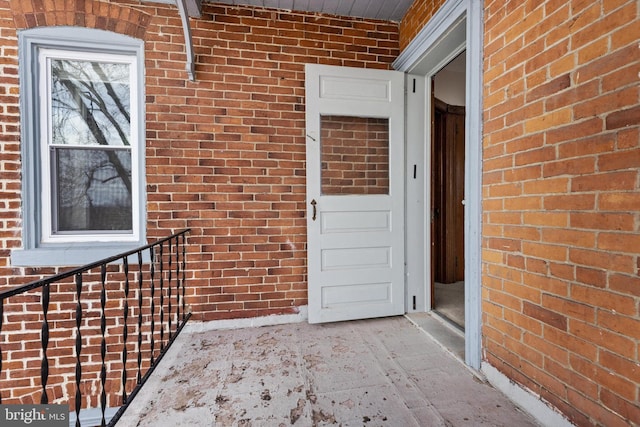 view of exterior entry with brick siding