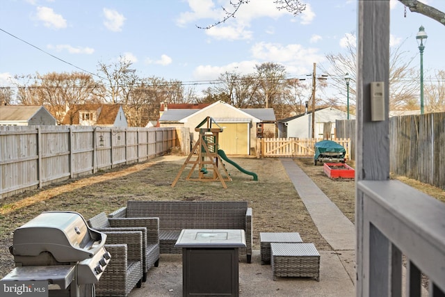 view of patio with area for grilling, a playground, and a fenced backyard