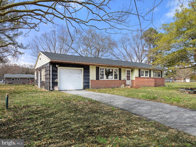 view of front facade featuring aphalt driveway, a front lawn, brick siding, and an attached garage