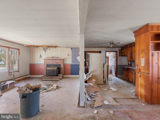 unfurnished living room featuring a baseboard radiator and a ceiling fan