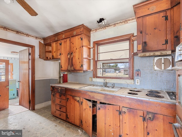 kitchen with a sink, brown cabinetry, and light countertops