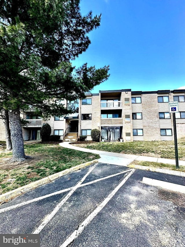 view of building exterior with uncovered parking