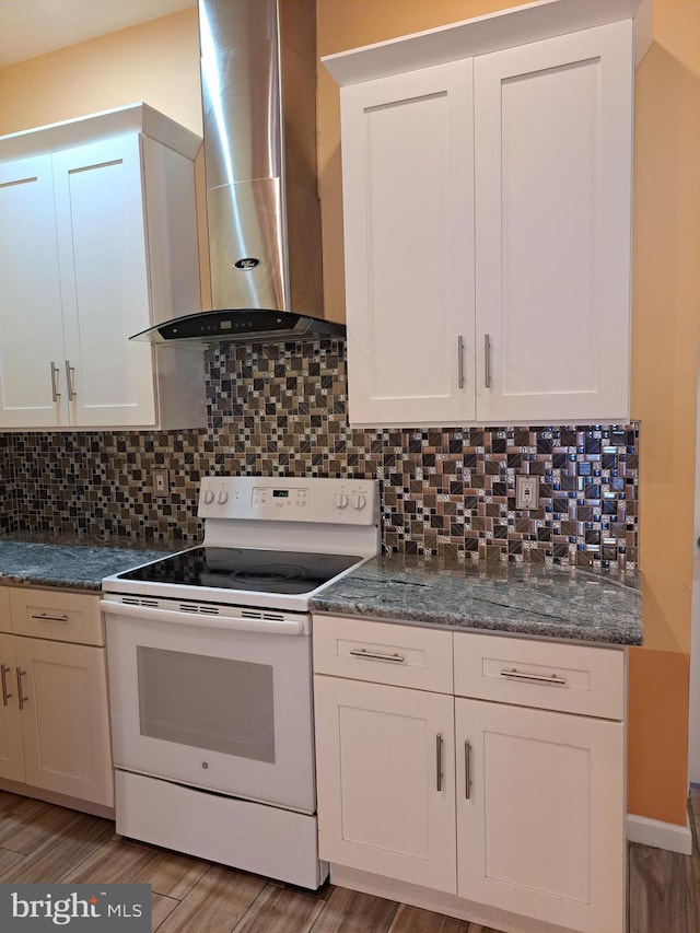 kitchen featuring tasteful backsplash, light wood-type flooring, wall chimney exhaust hood, and white electric range oven