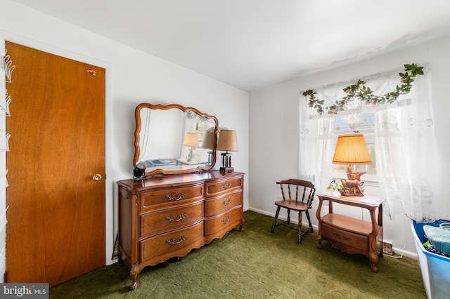 sitting room featuring carpet flooring and baseboards