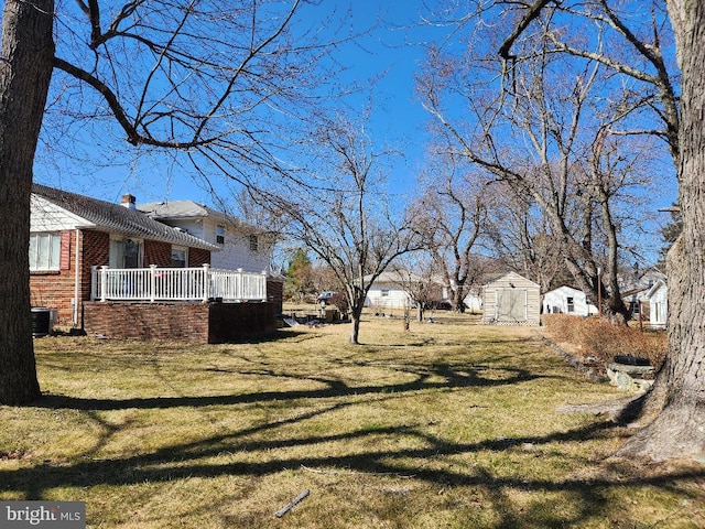 view of yard featuring a storage unit, an outbuilding, and cooling unit