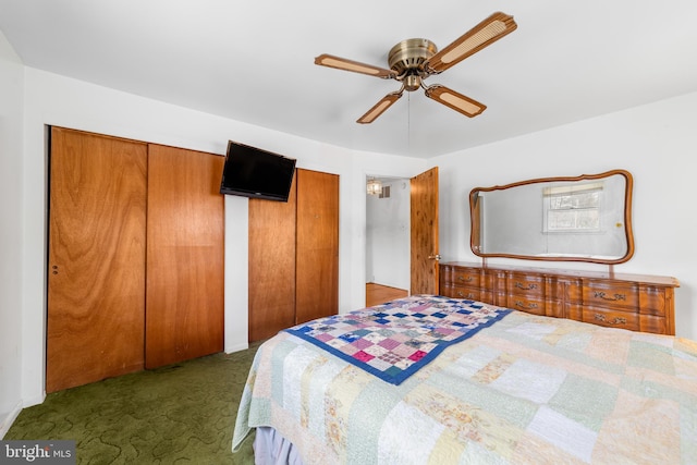 carpeted bedroom featuring two closets and a ceiling fan