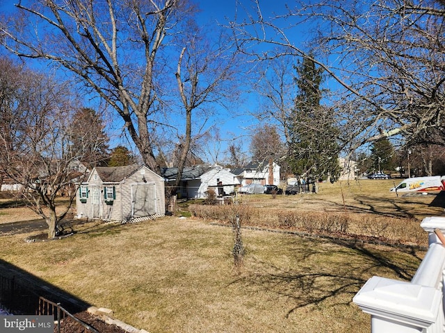 view of yard with an outdoor structure and a shed