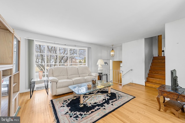 living area with stairway and light wood-type flooring