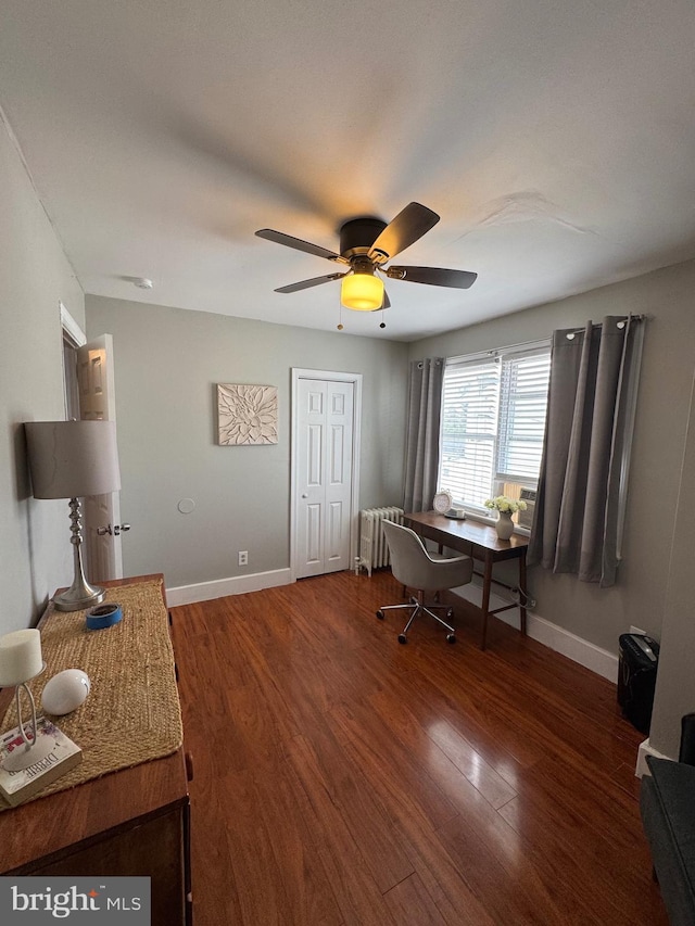 office featuring ceiling fan, baseboards, wood finished floors, and radiator heating unit