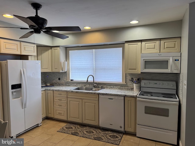 kitchen with a ceiling fan, a sink, white appliances, decorative backsplash, and light stone countertops