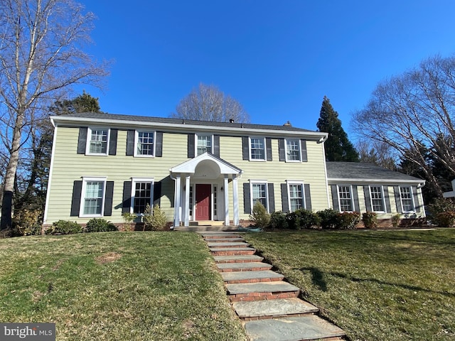 colonial-style house with a front lawn