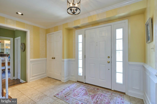 foyer with plenty of natural light, wainscoting, and visible vents