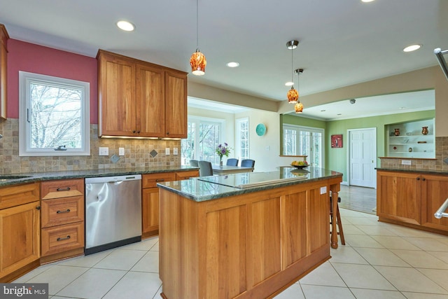 kitchen with brown cabinets, dishwasher, and light tile patterned flooring