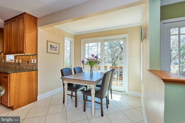 dining area featuring light tile patterned floors, french doors, baseboards, and ornamental molding