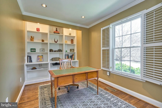 office area featuring visible vents, baseboards, wood finished floors, and crown molding