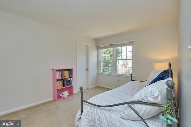 bedroom with baseboards and carpet floors