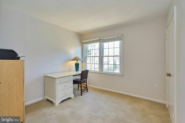 office space featuring baseboards and light colored carpet