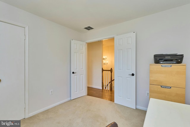 carpeted bedroom featuring baseboards and visible vents