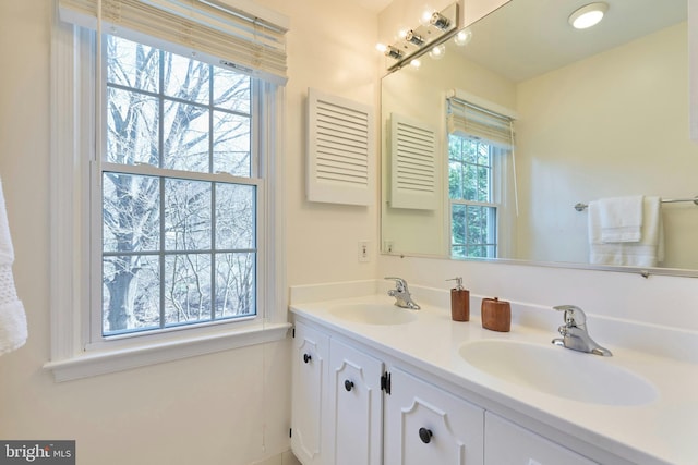 full bathroom featuring double vanity and a sink