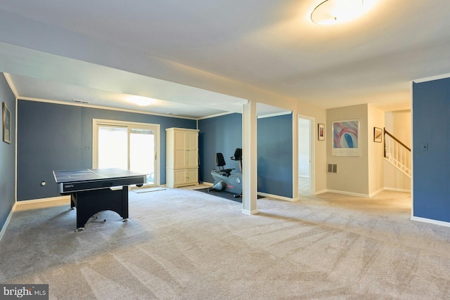 rec room with visible vents, baseboards, light colored carpet, and crown molding