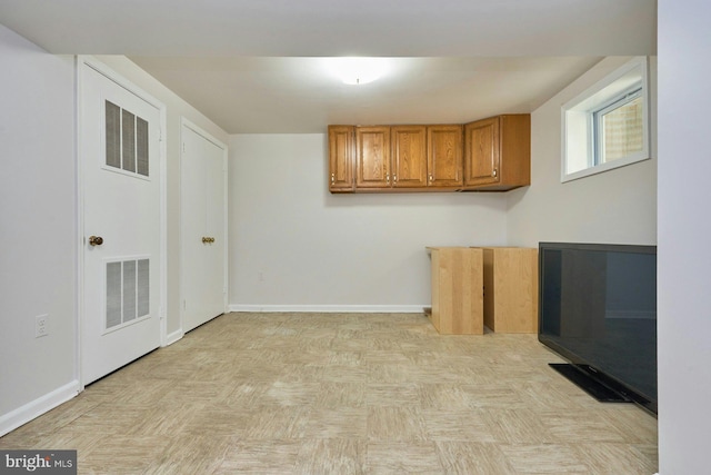 laundry area with visible vents and baseboards