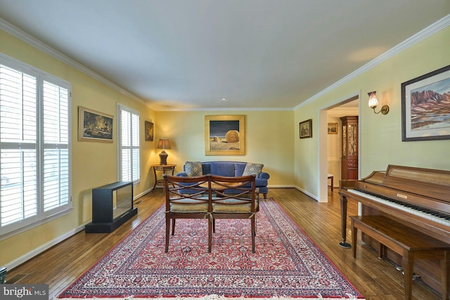 living room with crown molding, baseboards, and hardwood / wood-style floors