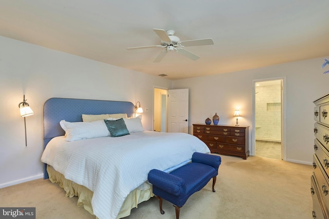 bedroom with ceiling fan, ensuite bath, baseboards, and light carpet