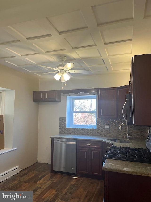 kitchen featuring dark wood-type flooring, a sink, stainless steel appliances, a baseboard heating unit, and backsplash