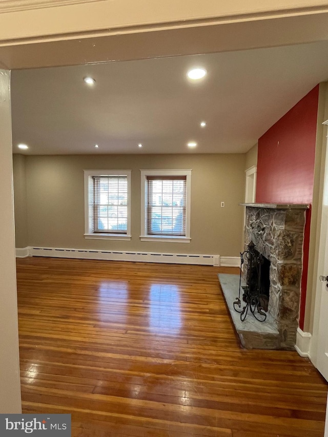 unfurnished living room with a fireplace, wood finished floors, and recessed lighting