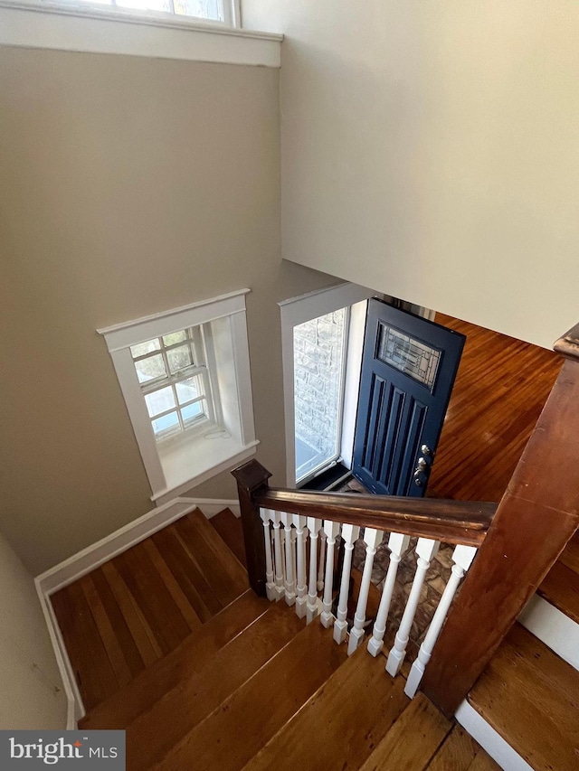 staircase with wood finished floors