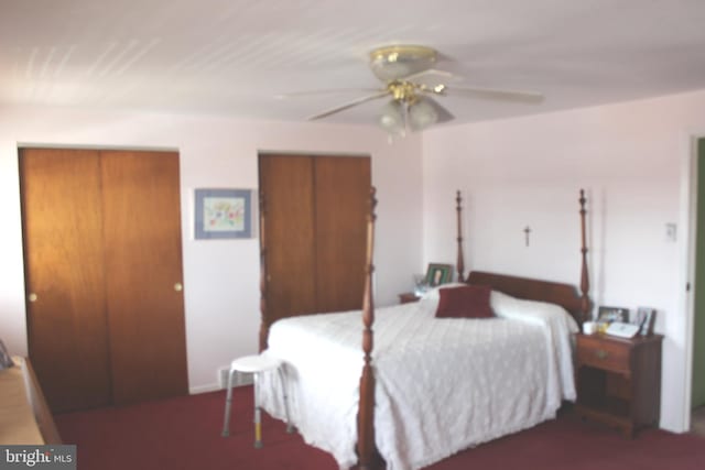 bedroom with a ceiling fan and two closets