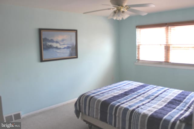 carpeted bedroom with baseboards and visible vents