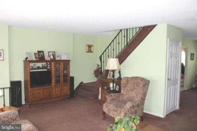 living room with stairs and carpet