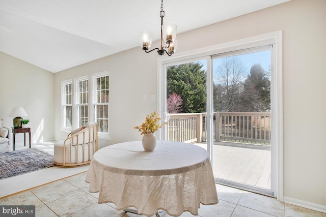 dining room featuring baseboards, lofted ceiling, a notable chandelier, and light tile patterned flooring